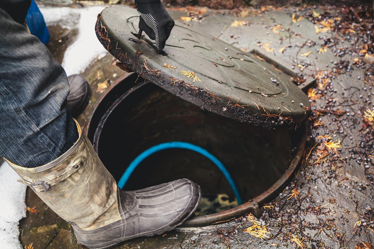plumber accessing municipal sewer drain